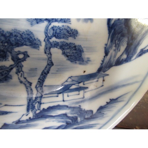 584 - Chinese blue and white shallow bowl decorated with a river landscape, 14.5cm diameter