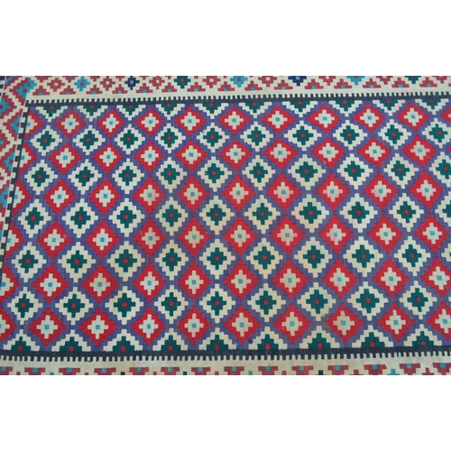 10 - Small Kelim rug with an all-over stylised flowerhead design in shades of red, blue, green and cream,... 