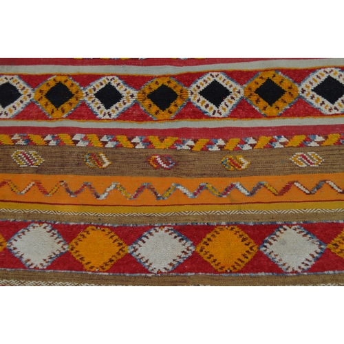 11 - North African rug of flatweave, piled and banded design in shades of orange, cream, red and yellow, ... 