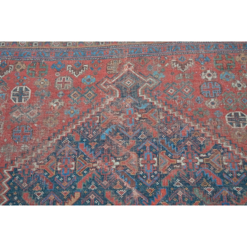 14 - Antique South West Persian rug with a lobed medallion and stylised Herati design on a red ground wit... 