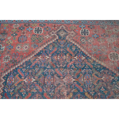 14 - Antique South West Persian rug with a lobed medallion and stylised Herati design on a red ground wit... 