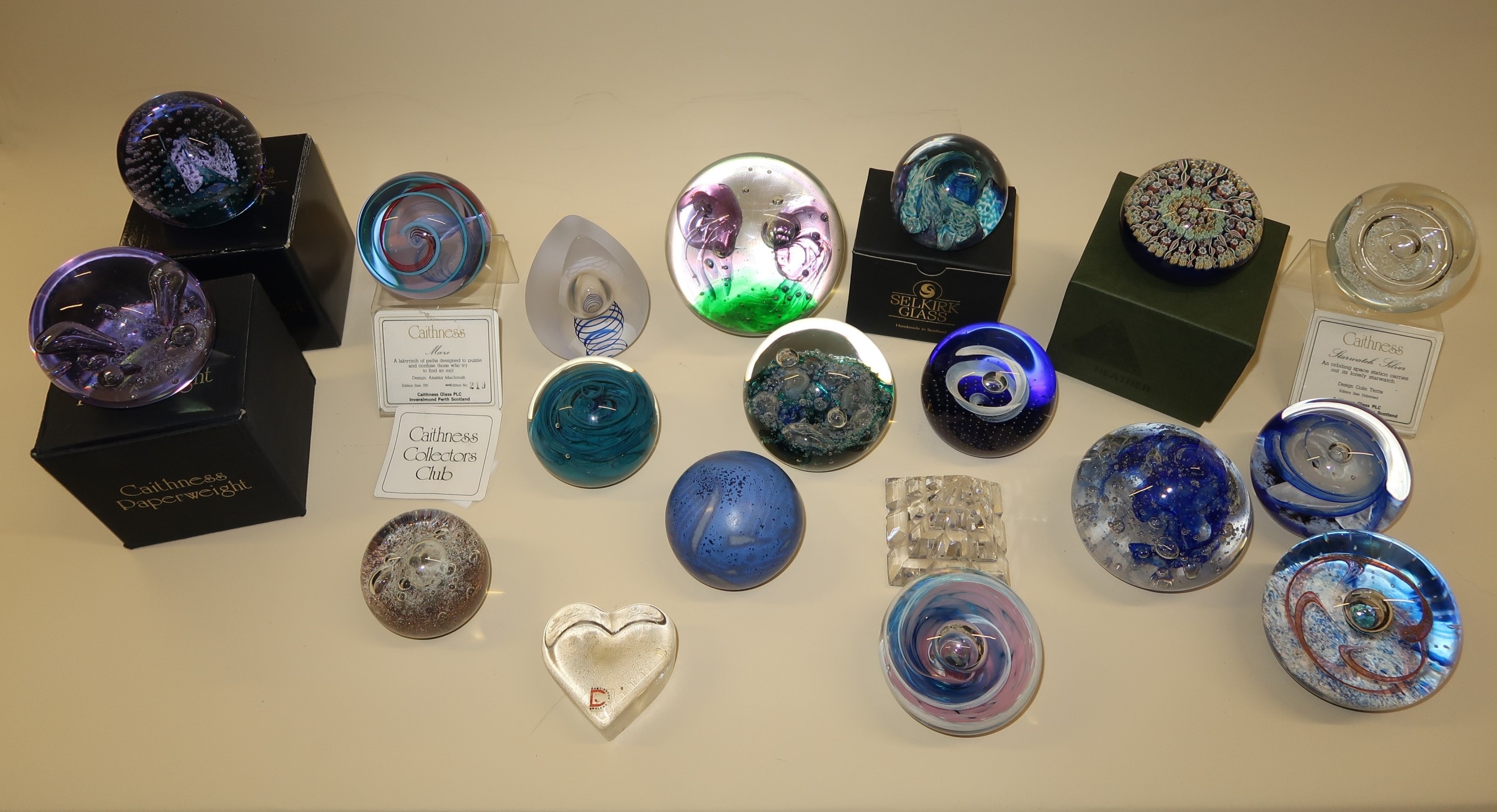 Box containing various glass paperweights including Caithness