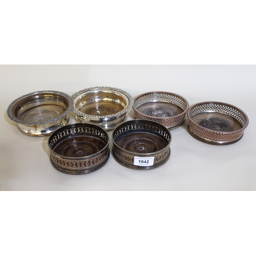 1042 - Two pairs of 19th Century plate on copper bottle coasters, together with two similar