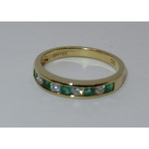 1159 - 14ct Yellow gold nine stone emerald and diamond half eternity ring, size 'N', 2.7g