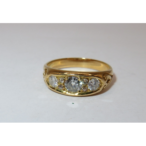 1163 - Unmarked high carat yellow metal seven stone diamond ring, the centre stone approximately 4.5mm diam... 