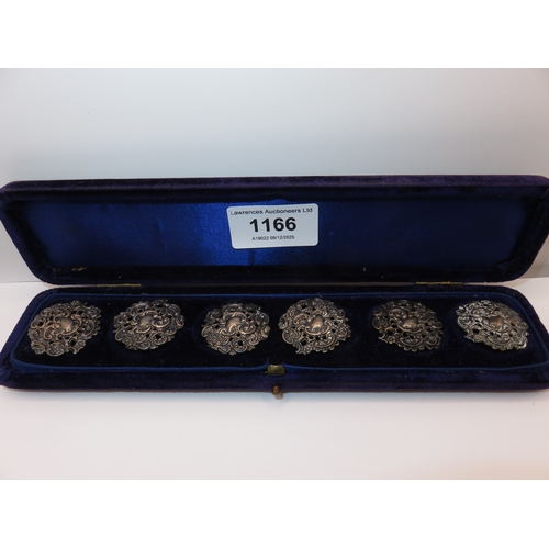 1166 - Cased set of six cast silver buttons in a fitted case