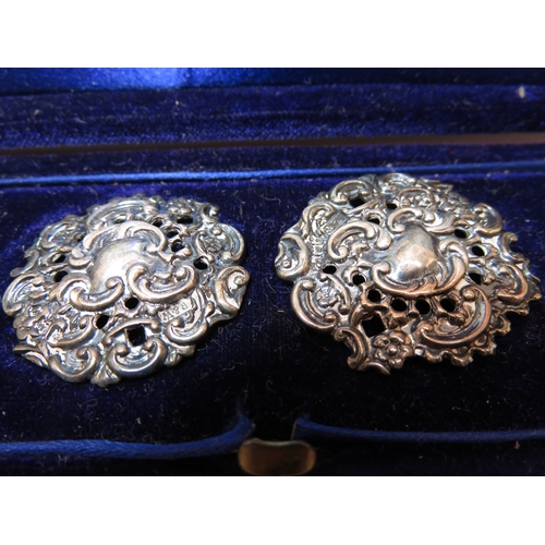 1166 - Cased set of six cast silver buttons in a fitted case