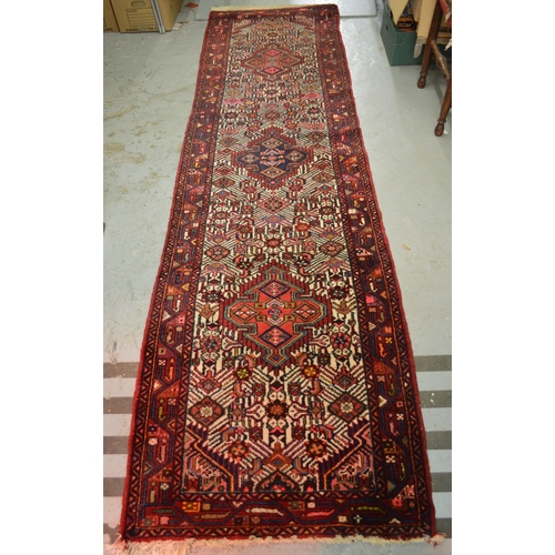 138 - Hamadan runner of triple medallion and floral design with multiple borders, 296 x 80cm