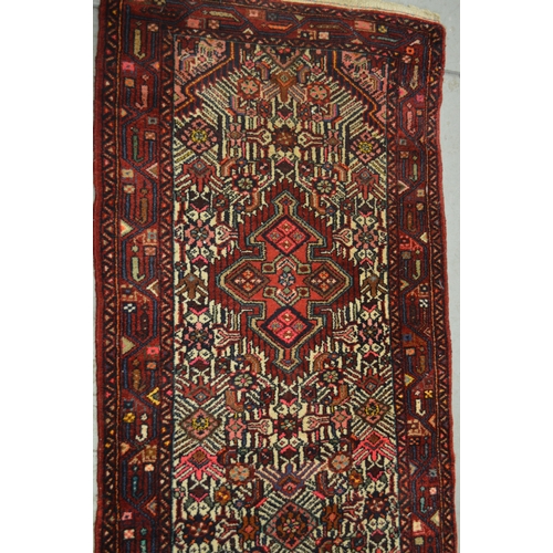 138 - Hamadan runner of triple medallion and floral design with multiple borders, 296 x 80cm