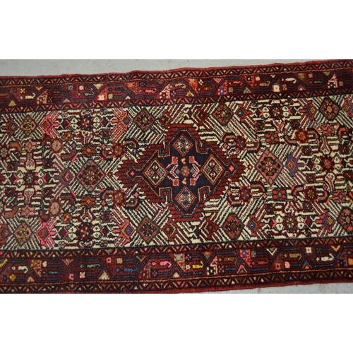 138 - Hamadan runner of triple medallion and floral design with multiple borders, 296 x 80cm