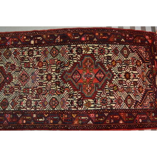 138 - Hamadan runner of triple medallion and floral design with multiple borders, 296 x 80cm