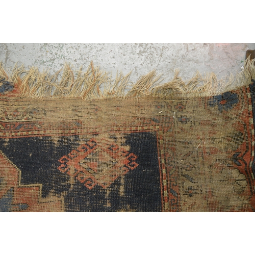 142 - Kazak rug having medallion design with red and blue ground having multiple borders (at fault)
