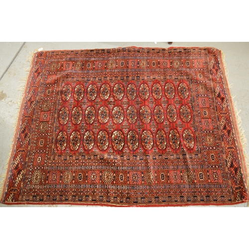 145 - Pakistan Tekke design rug having multiple borders on a dark red ground, 155 x 123cm