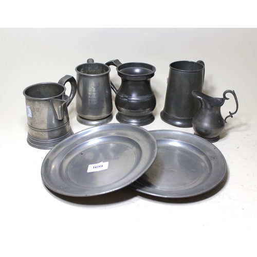 1699 - Two 18th Century pewter plates, 22cm diameter, together with three pewter tankards and two pewter ju... 