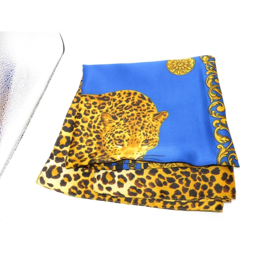 197 - Silk scarf with central leopard in blue panel bordered with black and leopard print, measures 88cm s... 