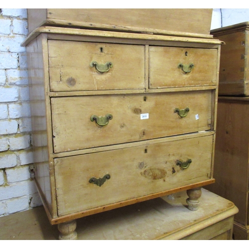 2010 - Small stripped pine chest of two short and two long drawers with brass handles and turned supports, ... 