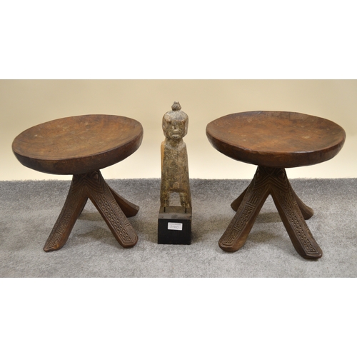 2140 - Pair of Nigerian circular (carved from the solid) stools with splayed carved decorated supports, tog... 
