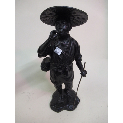 2197 - Genryusai Seiya (Japanese Meiji period), dark patinated bronze figure, man wearing a wide brimmed ha... 