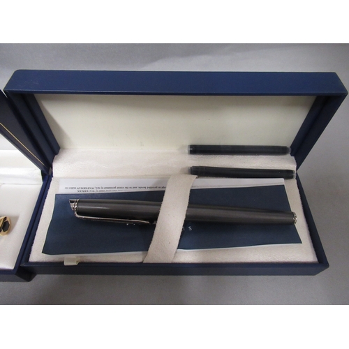 317 - Two cased Waterman fountain pens, together with two other pens