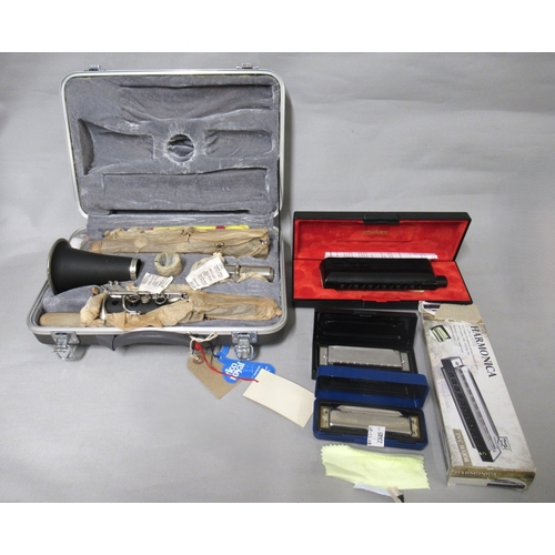 318 - Odyssey clarinet in a fitted case, together with two Hohner harmonicas and another