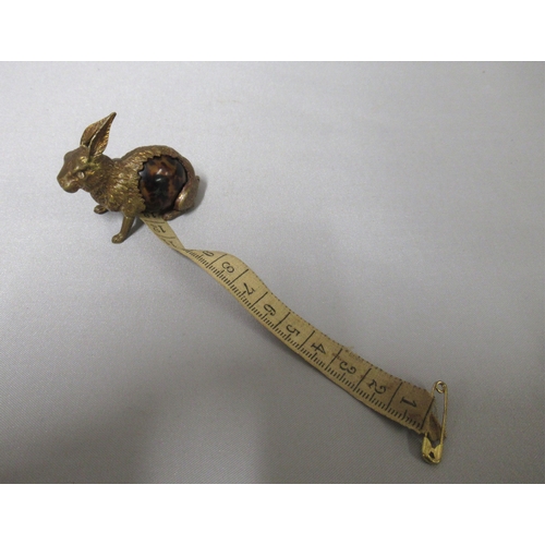 329 - Brass and simulated tortoiseshell tape measure in the form of a rabbit