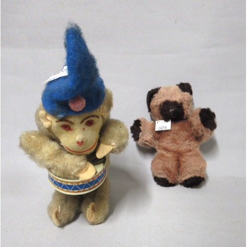 432 - Mid 20th Century clockwork toy in the form of a monkey playing a drum, together with another small s... 