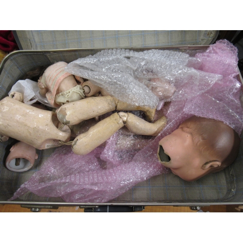 677 - Three suitcases containing a collection of various doll bodies and dolls