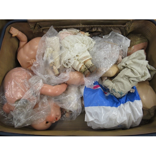 677 - Three suitcases containing a collection of various doll bodies and dolls