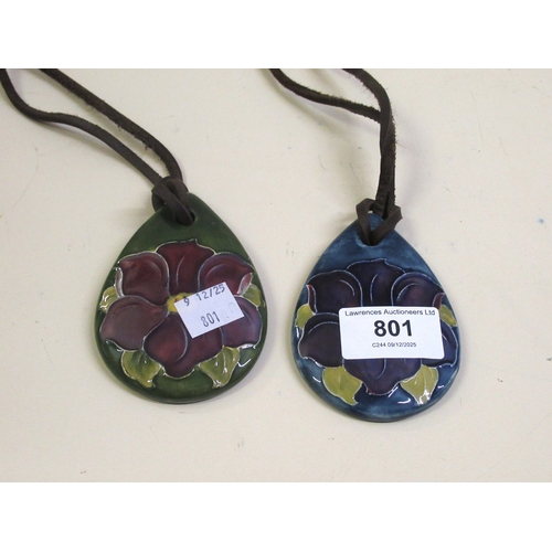 801 - Two Moorcroft ' Clematis ' pendants with original leather thongs, circa 1970s
