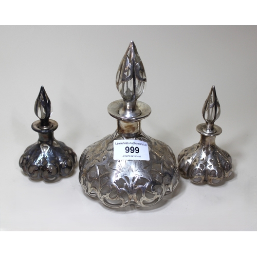 999 - Continental white metal mounted glass perfume bottle, together with a pair of matching smaller bottl... 