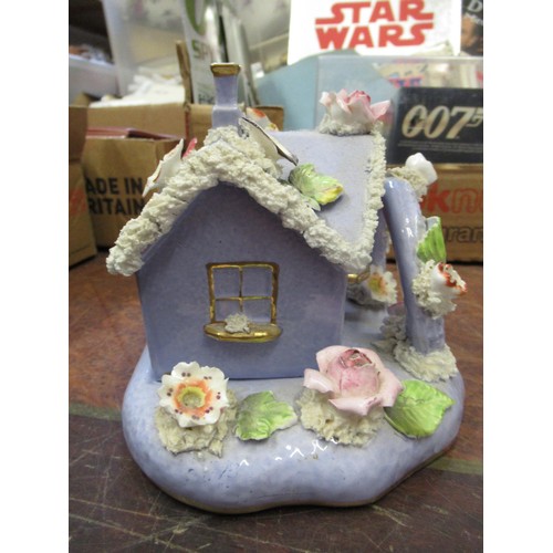 927 - 19th Century English floral encrusted pastille burner cottage with stand, and a small quantity of ot... 