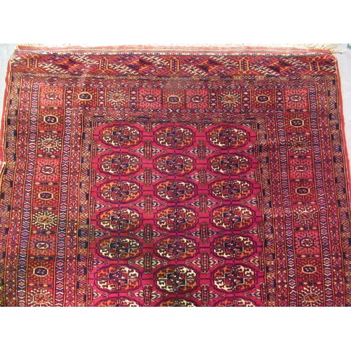 145 - Pakistan Tekke design rug having multiple borders on a dark red ground, 155 x 123cm