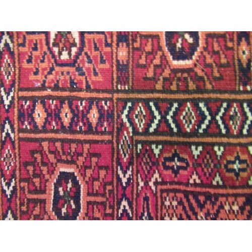 145 - Pakistan Tekke design rug having multiple borders on a dark red ground, 155 x 123cm