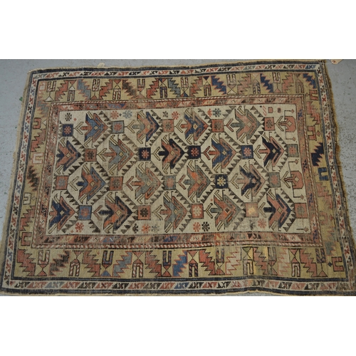 15 - Small Kazak rug with a repeating flower head design on an off-white ground with borders (damages and... 