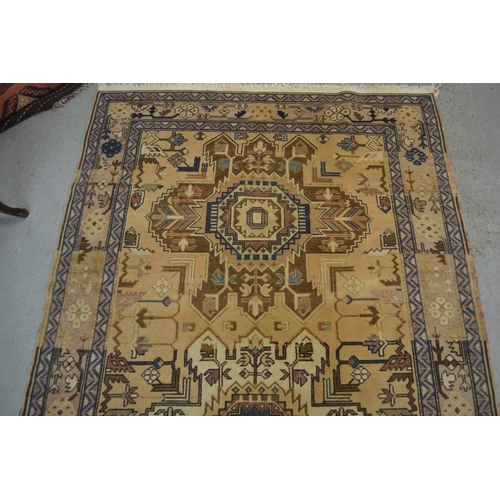 18 - Kurdish rug with triple medallion design on a beige ground with borders, 226 x 125cm approximately