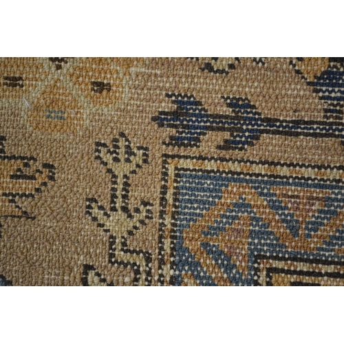 18 - Kurdish rug with triple medallion design on a beige ground with borders, 226 x 125cm approximately