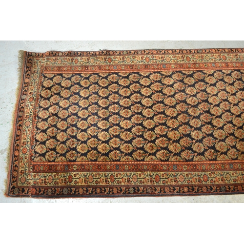 19 - Good quality central Persian runner, with an all over boteh design on a midnight blue ground with bo... 