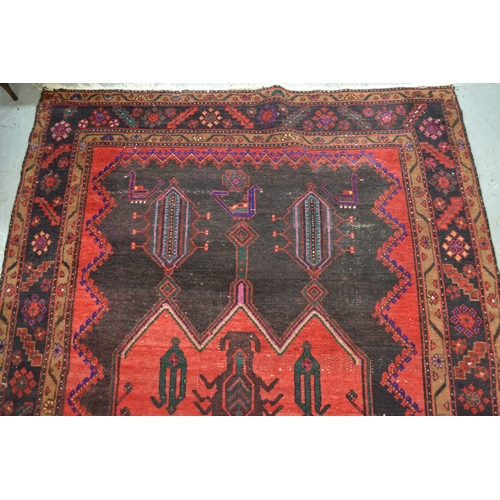 24 - Large Kurdish rug with a geometric red ground centre medallion on a dark ground with further stylise... 