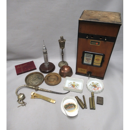 296 - Early 20th Century wooden cigarette dispensing machine, various tobacco tins and a cigar press