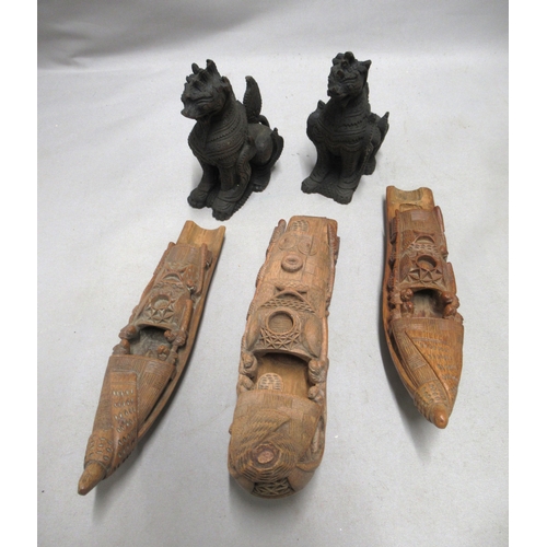 314 - Three Chinese carved model boats, the longest 25cm, together with a pair of carved dogs of foe