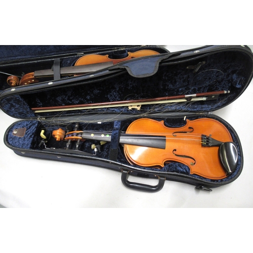 337 - Two modern violins in cases, together with a Bundy cased clarinet