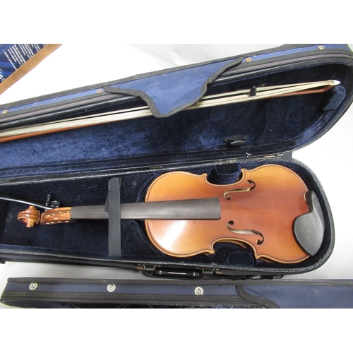 337 - Two modern violins in cases, together with a Bundy cased clarinet