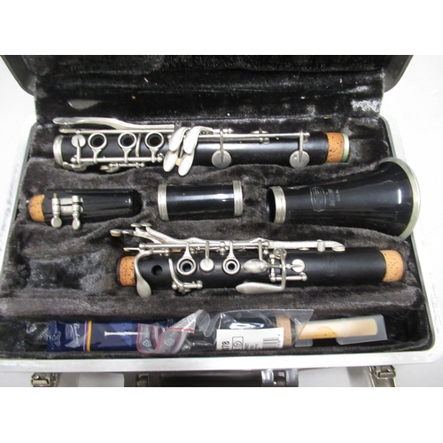 337 - Two modern violins in cases, together with a Bundy cased clarinet