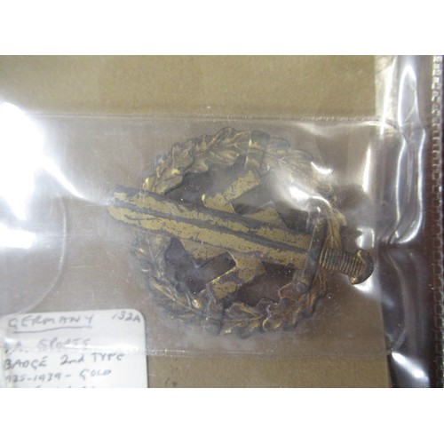 359 - Six German World War II pass books, associated papers and badges