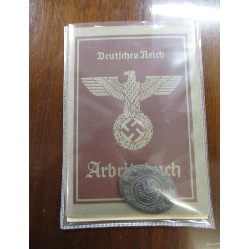 359 - Six German World War II pass books, associated papers and badges