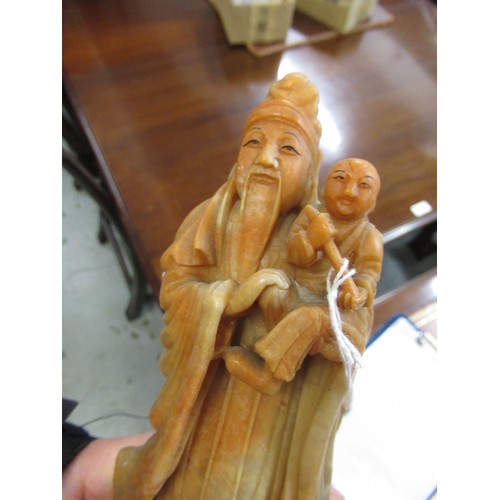 84 - Carved soapstone group of birds, together with a carved soapstone figure of a Chinese deity