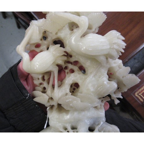 84 - Carved soapstone group of birds, together with a carved soapstone figure of a Chinese deity