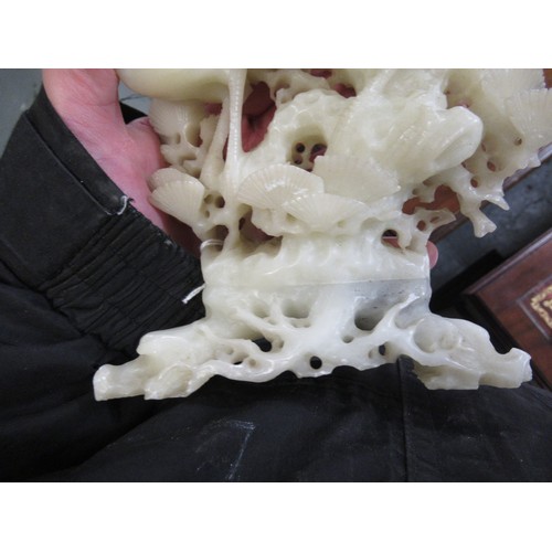 84 - Carved soapstone group of birds, together with a carved soapstone figure of a Chinese deity