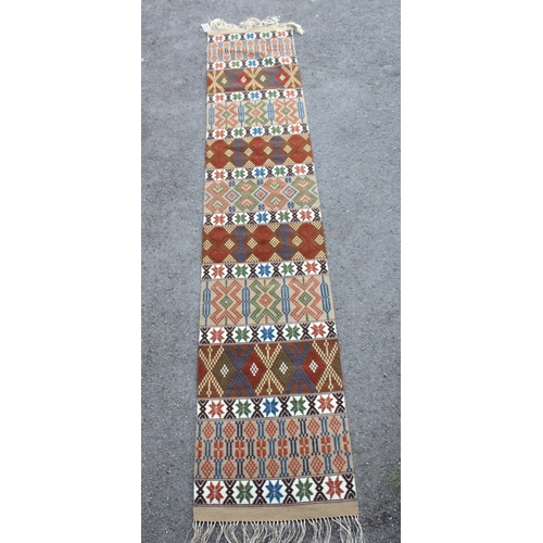 19 - Chinese woollen rug of vase design, together with two tribal wall hangings