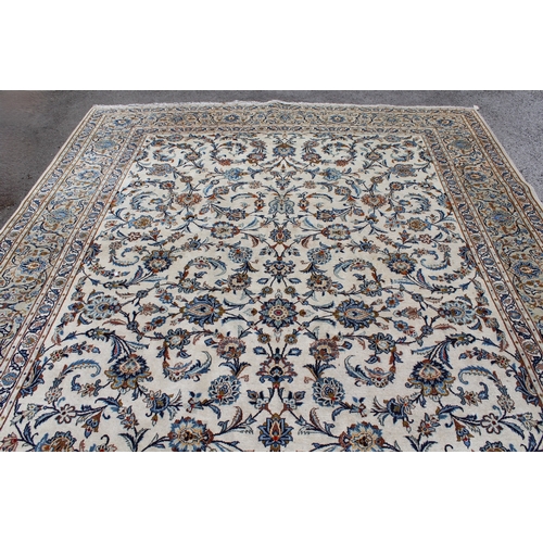 22 - Tabriz carpet of all-over floral design, with multiple borders, on a beige ground, 414cm x 286cm